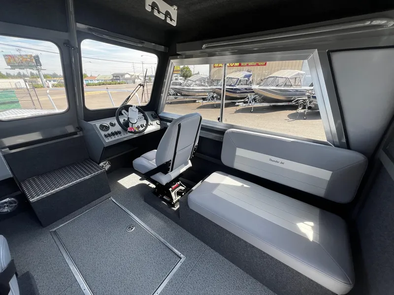 Slide: The Image of Interior of 2024 Thunder Jet 24 Alexis Pro boat, featuring seating and control panel. - 21