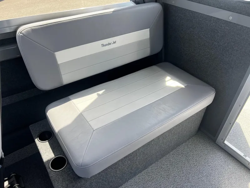 Slide: The Image of 2024 Thunder Jet 24 Alexis Pro interior seating with cup holders, gray upholstery. - 22