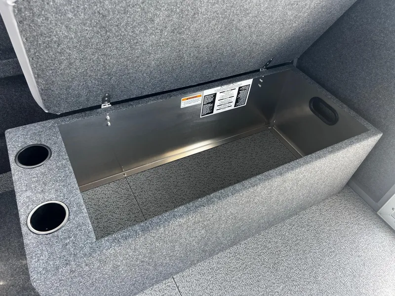Slide: The Image of 2024 Thunder Jet 24 Alexis Pro storage compartment with cup holders and carpeted interior. - 23
