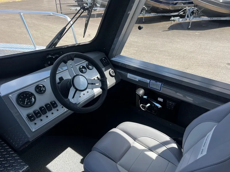 Slide: The Image of 2024 Thunder Jet 24 Alexis Pro boat interior with steering wheel and control panel. - 25