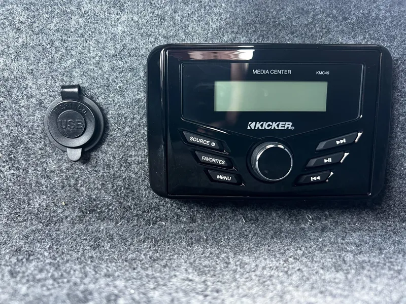 Slide: The Image of 2024 Thunder Jet 24 Alexis Pro media center with USB port on gray carpeted surface. - 28