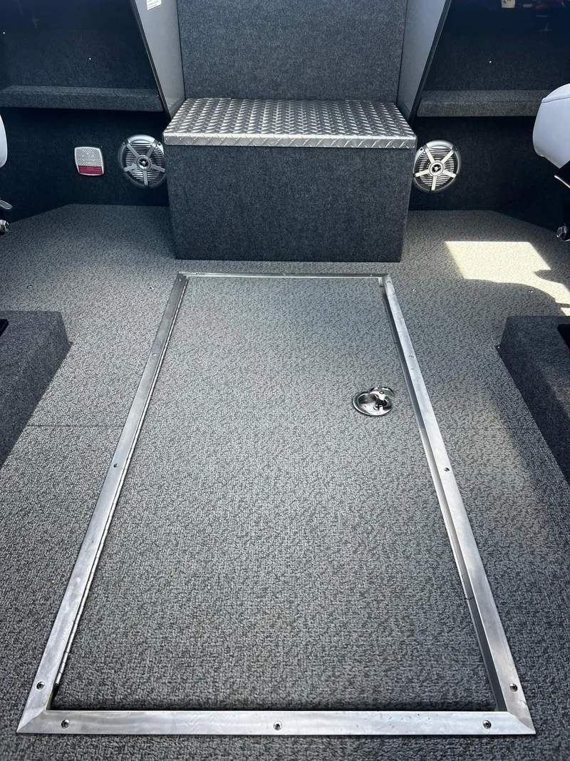 Slide: The Image of 2024 Thunder Jet 24 Alexis Pro boat interior with storage compartment and speakers. - 30