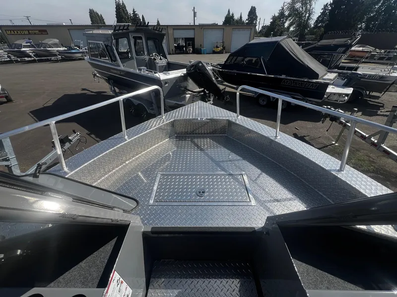 Slide: The Image of 2024 Thunder Jet 24 Alexis Pro boat, aluminum deck, parked in a marina. - 32