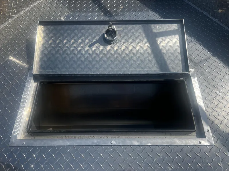 Slide: The Image of Open storage compartment on 2024 Thunder Jet 24 Alexis Pro boat. - 33