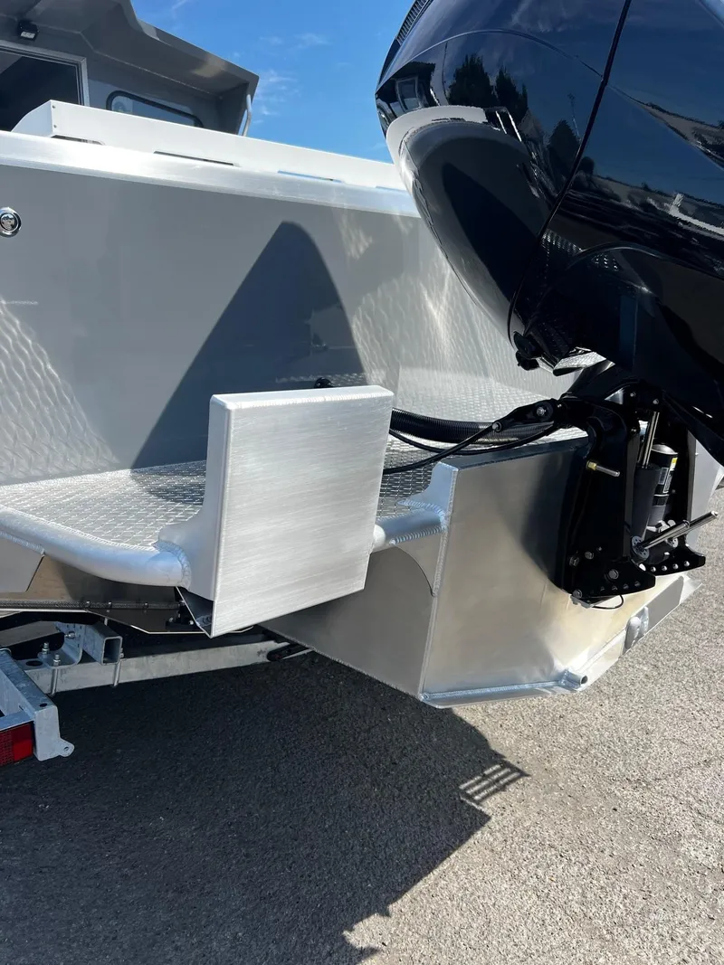 Slide: The Image of 2024 Thunder Jet 24 Alexis Pro boat with powerful outboard motor, rear view. - 35