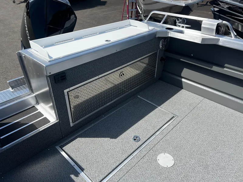 Slide: The Image of 2024 Thunder Jet 24 Alexis Pro boat interior with storage compartments and sleek design. - 9