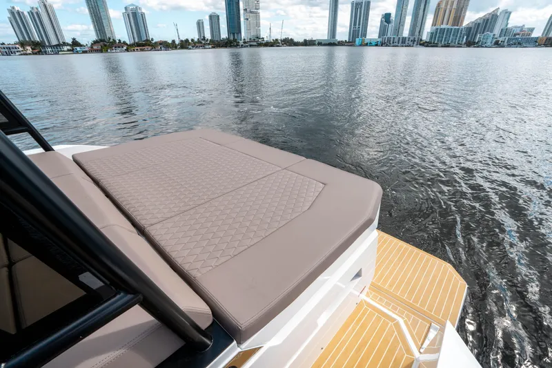 Slide: The Image of De Antonio Yachts D32 OPEN 2025, luxury deck view with city skyline backdrop. - 11