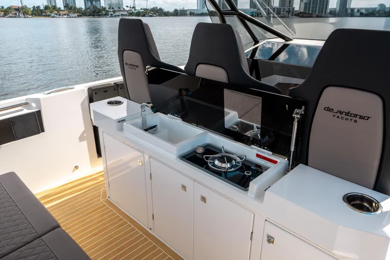 Slide: The Image of De Antonio Yachts D32 OPEN 2025 interior with sleek kitchen and seating area. - 24