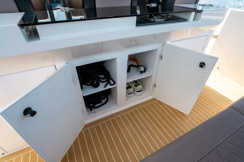 Slide: The Image of Open storage cabinet on 2025 De Antonio Yachts D32 OPEN, showcasing interior compartments. - 26