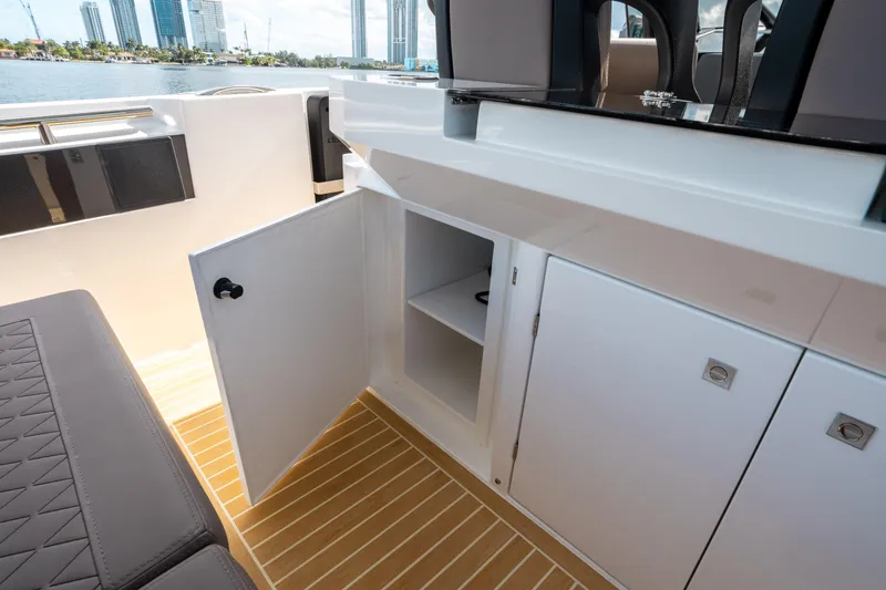 Slide: The Image of 2025 De Antonio Yachts D32 OPEN interior with open storage cabinet and modern design. - 27