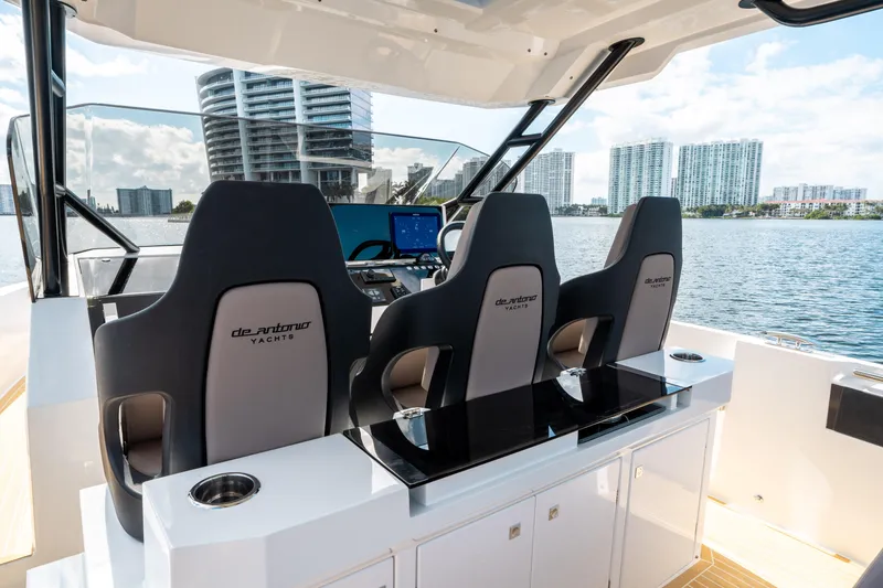 Slide: The Image of 2025 De Antonio Yachts D32 OPEN helm with modern seating and cityscape view. - 31