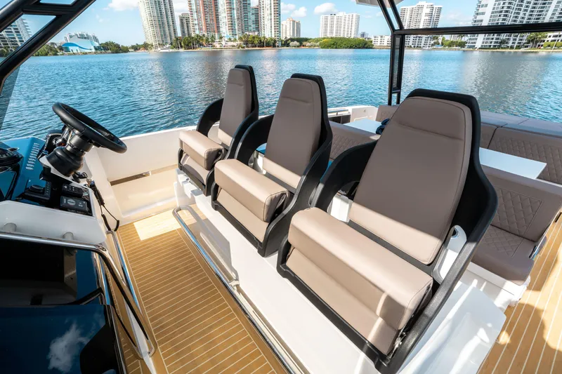 Slide: The Image of Luxury seating on 2025 De Antonio Yachts D32 OPEN, overlooking waterfront cityscape. - 32