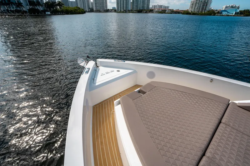 Slide: The Image of 2025 De Antonio Yachts D32 OPEN on serene water with city skyline. - 36