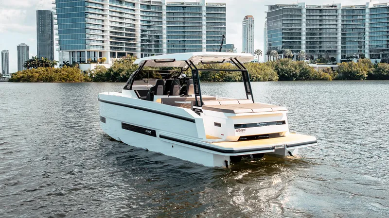 Slide: The Image of 2025 De Antonio Yachts D32 OPEN cruising near modern city skyline. - 4