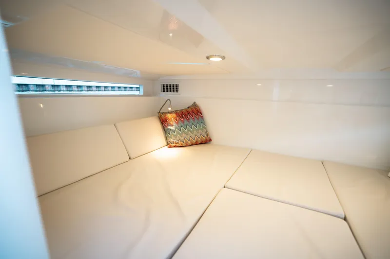Slide: The Image of Interior cabin of 2025 De Antonio Yachts D32 OPEN with cozy seating and colorful pillow. - 49