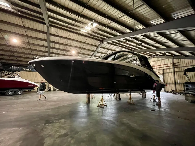 Slide: The Image of 2023 Sea Ray Sundancer 370 OB yacht in a spacious indoor storage facility. - 12