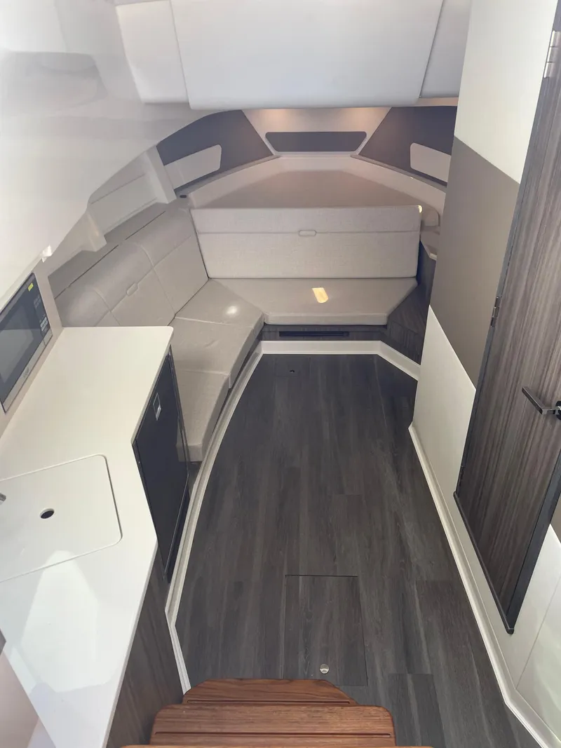 Slide: The Image of 2023 Sea Ray Sundancer 370 OB interior with modern design and sleek wood flooring. - 16