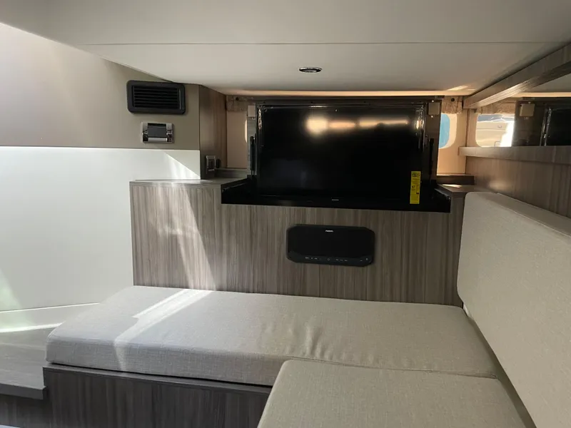 Slide: The Image of Interior of 2023 Sea Ray Sundancer 370 OB with TV and seating area. - 18