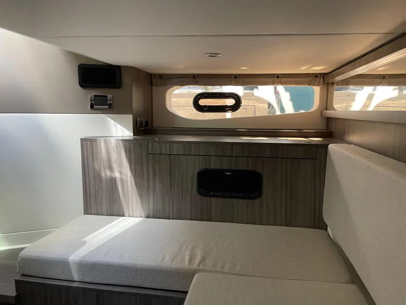 Slide: The Image of Interior cabin of 2023 Sea Ray Sundancer 370 OB with modern seating and windows. - 19