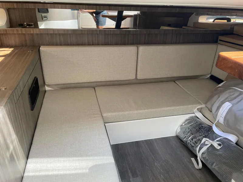 Slide: The Image of 2023 Sea Ray Sundancer 370 OB interior with beige seating and modern wood accents. - 20
