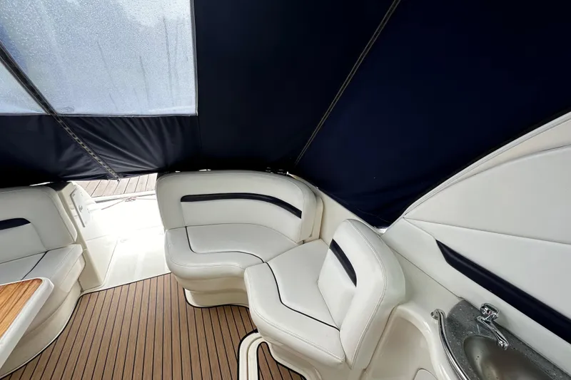 Slide: The Image of 2006 Sea Ray 38 Sundancer interior with white seating and wood flooring. - 34