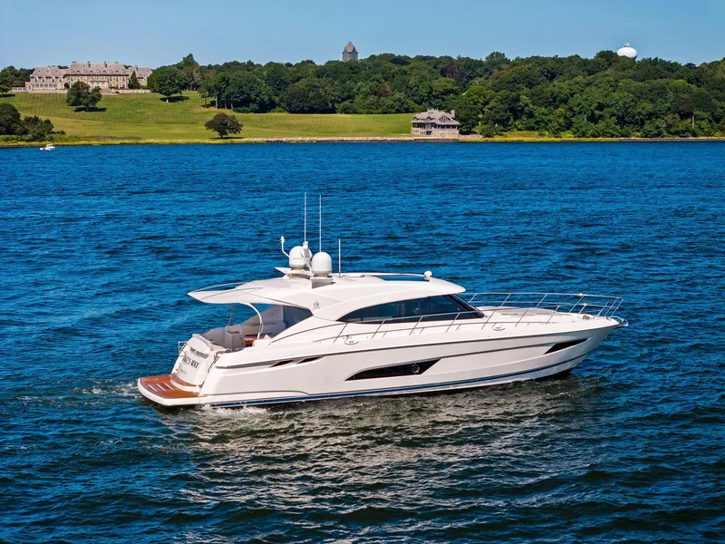 Slide: The Image of 2017 Riviera Sport Yacht cruising on a scenic lake with lush green shoreline. - 11