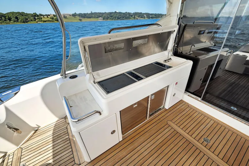 Slide: The Image of Outdoor kitchen on 2017 Riviera Sport Yacht with scenic water view. - 19