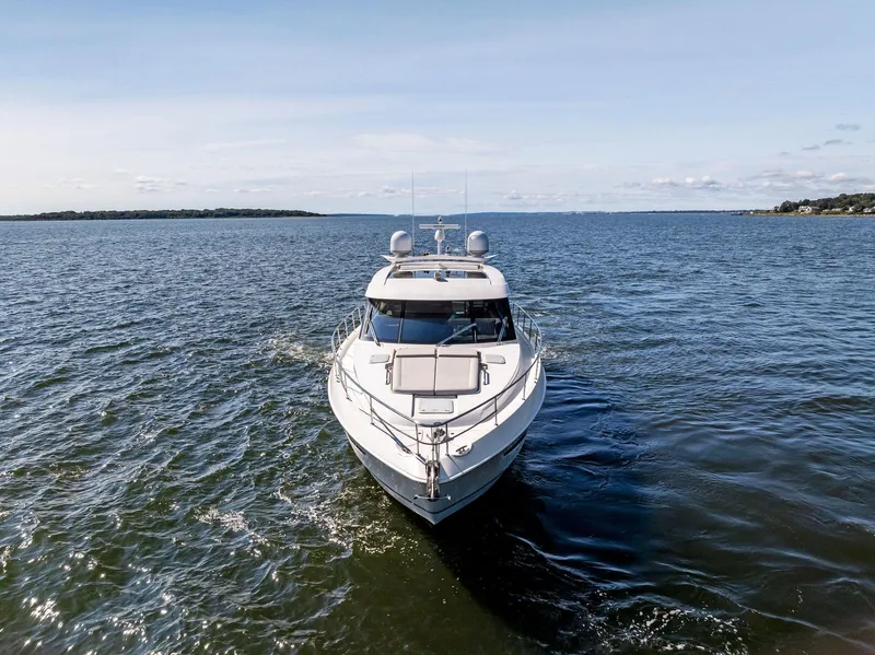 Slide: The Image of 2017 Riviera Sport Yacht cruising on open water under clear skies. - 2