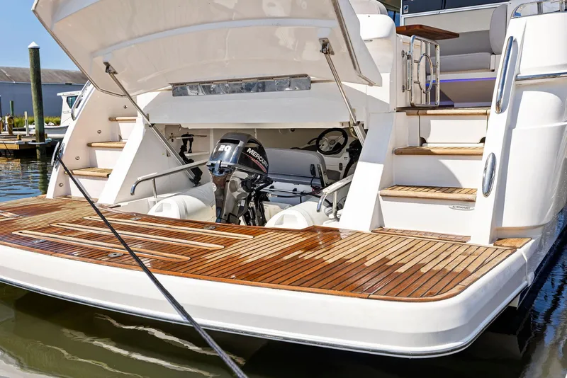 Slide: The Image of 2017 Riviera Sport Yacht with open engine compartment and wooden deck. - 25