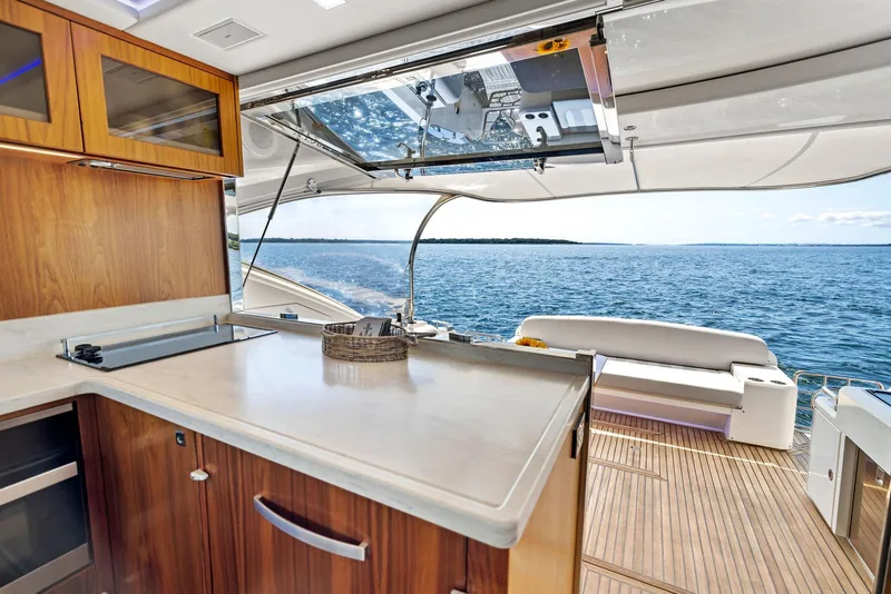 Slide: The Image of Luxurious 2017 Riviera Sport Yacht interior with ocean view and modern kitchen. - 27