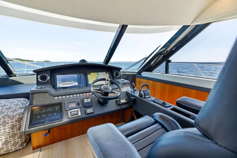 Slide: The Image of 2017 Riviera Sport Yacht helm with modern controls and ocean view. - 38