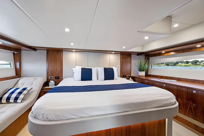 Slide: The Image of Luxurious 2017 Riviera Sport Yacht bedroom with elegant wood finishes and modern decor. - 43