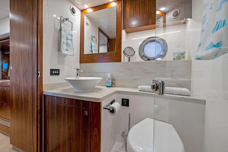 Slide: The Image of Luxurious bathroom in 2017 Riviera Sport Yacht with modern fixtures and wooden cabinetry. - 47