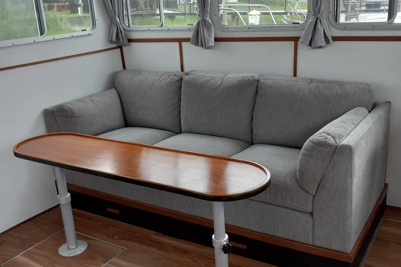 Slide: The Image of Gray sofa and wooden table in 2021 Willis Beal 35 Extended Pilothouse interior. - 19