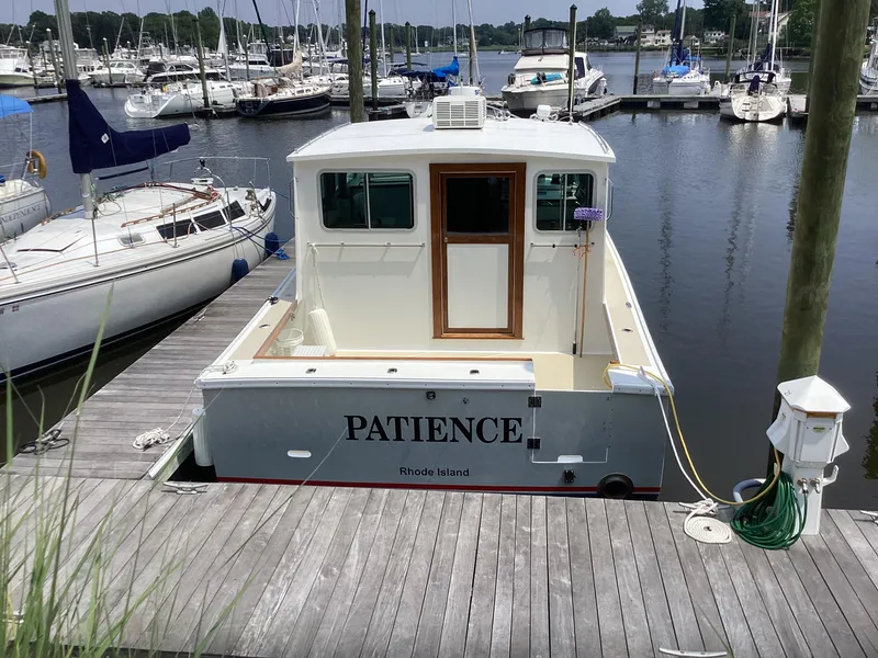 Slide: The Image of Willis Beal 35 Extended Pilothouse 2021 boat named "Patience" docked in a marina. - 2