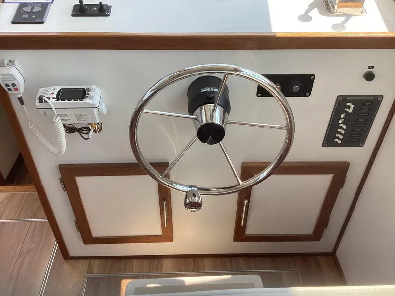 Slide: The Image of Steering wheel and control panel of 2021 Willis Beal 35 Extended Pilothouse boat. - 23