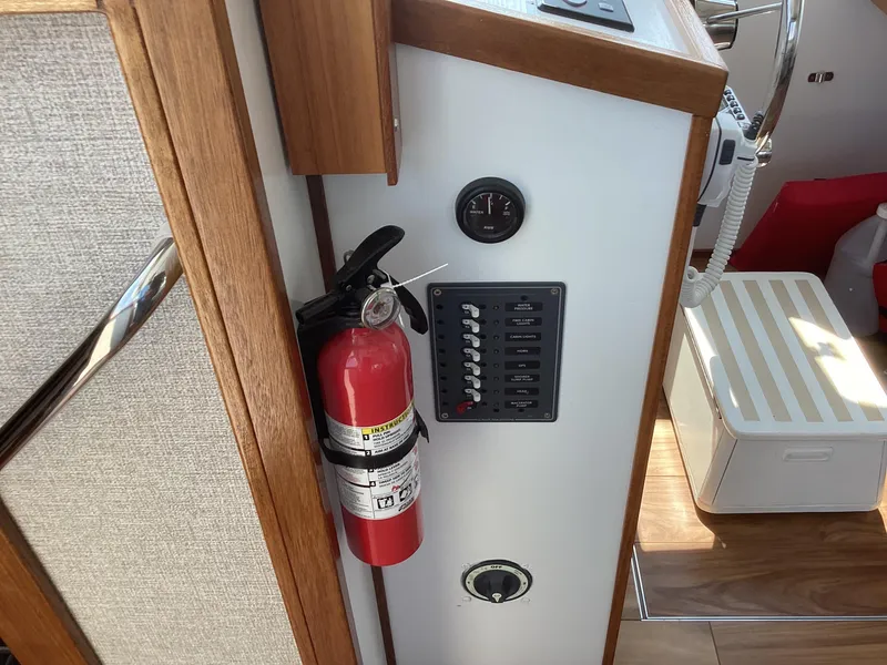 Slide: The Image of Fire extinguisher and control panel in 2021 Willis Beal 35 Extended Pilothouse boat interior. - 24