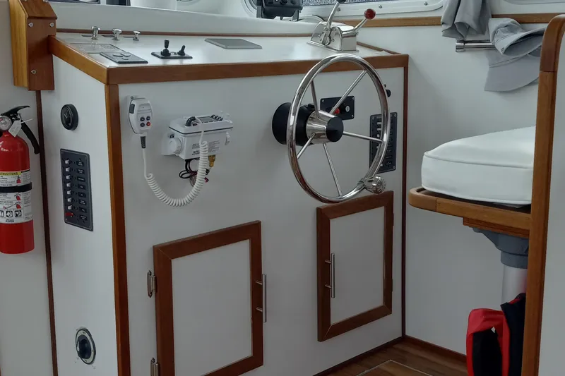 Slide: The Image of Interior helm of 2021 Willis Beal 35 Extended Pilothouse with steering wheel and controls. - 25