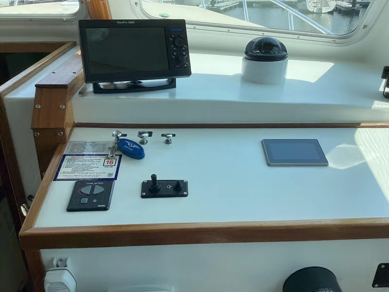 Slide: The Image of Pilothouse dashboard of 2021 Willis Beal 35 Extended, featuring navigation equipment and controls. - 27