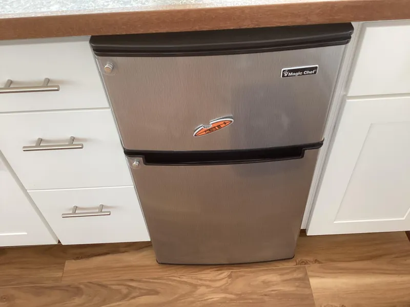 Slide: The Image of Compact stainless steel fridge in a modern kitchen setting, 2021 Willis Beal model. - 29