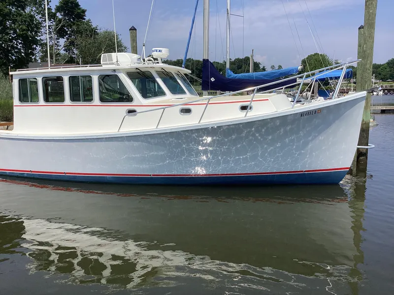 Slide: The Image of 2021 Willis Beal 35 Extended Pilothouse boat docked in a marina. - 3