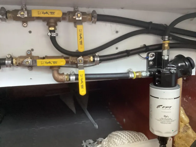 Slide: The Image of Engine compartment of 2021 Willis Beal 35 Extended Pilothouse with fuel filter and valves. - 34