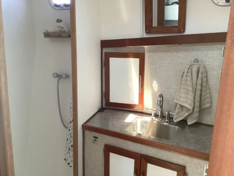 Slide: The Image of 2021 Willis Beal 35 Extended Pilothouse bathroom with sink, mirror, and shower. - 42