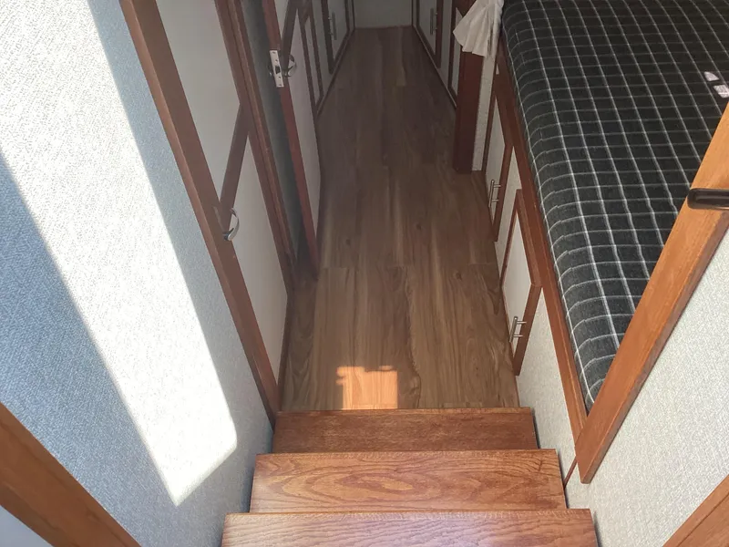 Slide: The Image of Interior of 2021 Willis Beal 35 Extended Pilothouse with wooden stairs and hallway. - 43