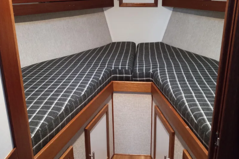 Slide: The Image of Cozy cabin interior of 2021 Willis Beal 35 Extended Pilothouse with checkered bedding. - 44