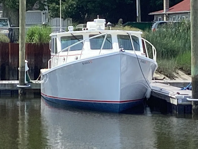 Slide: The Image of 2021 Willis Beal 35 Extended Pilothouse boat docked in a marina. - 5