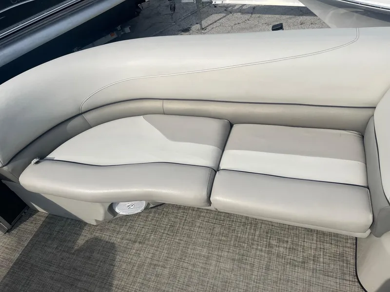 Slide: The Image of 2022 Cypress Cay Seabreeze 232 boat interior with gray cushioned seating. - 2