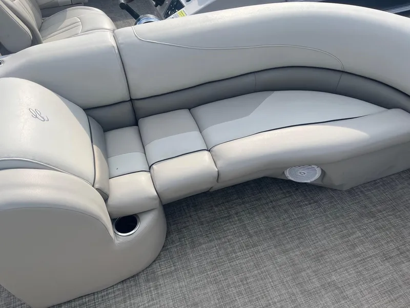 Slide: The Image of 2022 Cypress Cay Seabreeze 232 boat interior with beige seating and cup holder. - 3