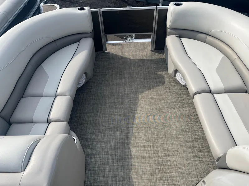 Slide: The Image of 2022 Cypress Cay Seabreeze 232 boat interior with gray seating and carpet flooring. - 4