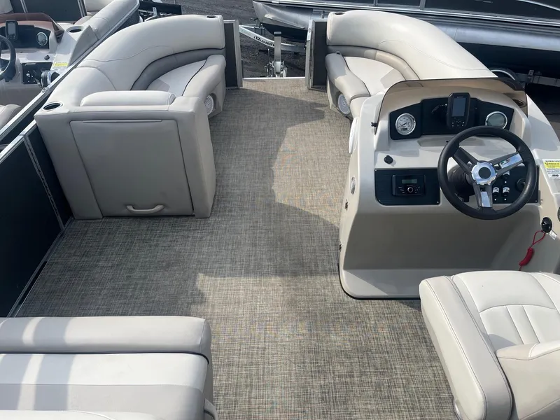 Slide: The Image of 2022 Cypress Cay Seabreeze 232 pontoon boat interior with plush seating and modern helm. - 6